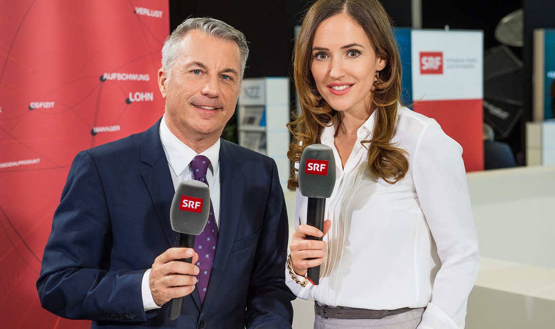 Die Moderatoren Patrizia Laeri und Reto Lipp mit Mikrophon in der Hand