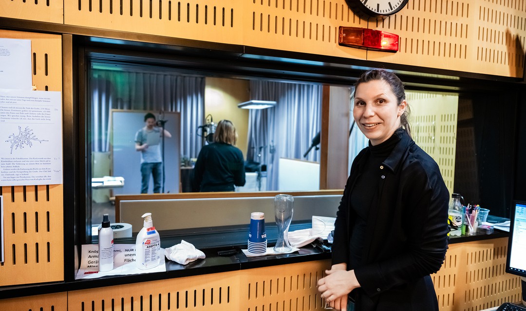 Die Autorin Gianna Molinari steht im Tonstudio. Im Hintergrund: Sven Schelker und Henni Jörissen.