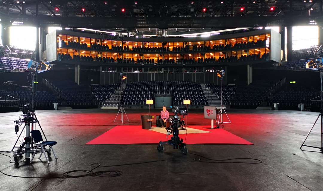 Eine Bühne ist im leeren Hallenstadion aufgebaut.