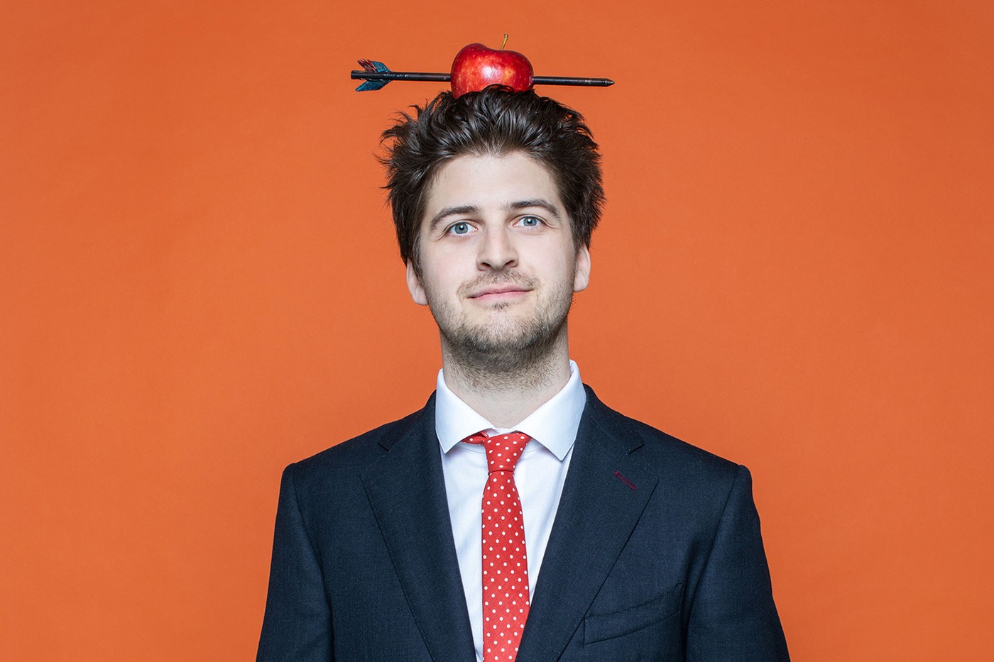Patrick Karpiczenko hat einen Apfel auf dem Kopf, welcher von einem Pfeil durchbohrt ist